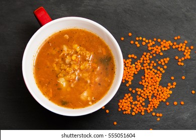 Red lentil soup on dark stone backgroud, top view