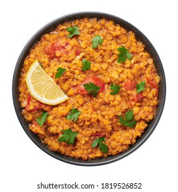 Red lentils dal in black bowl isolated on white background. Lentils tomato dhal is indian cuisine dish with lemon and ciliantro. Indian food. Asian vegetarian meal