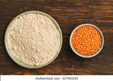 Red Lentils And Lentil Flour In Small Bowls