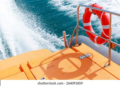 Red Lifebuoy Hanging On Steel Railings Of Safety Rescue Boat