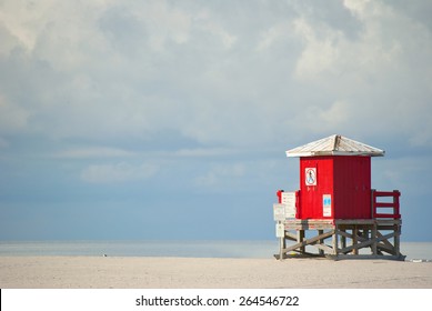 Red Lifeguard Beach Shack On An Otherwise Empty Beach.