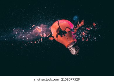 red light bulb breaking on black. high speed photography.