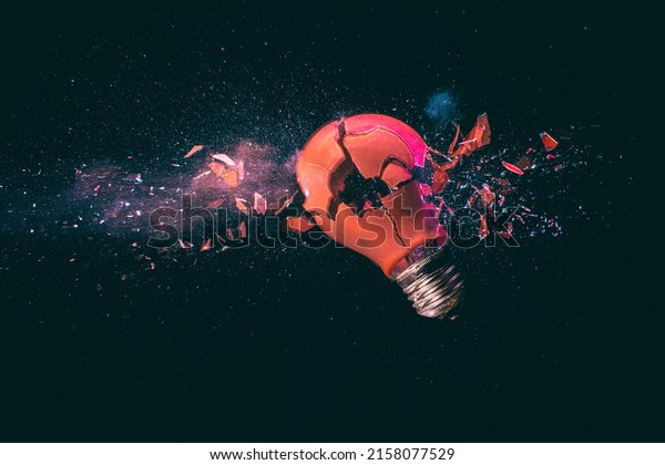 red\
light bulb breaking on black. high speed\
photography.