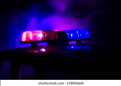 Red Light Flasher Atop Of A Police Car. City Lights On The Background.