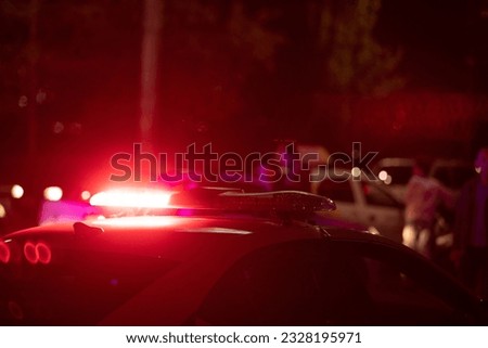 Red light flasher. Police car at night time in the city