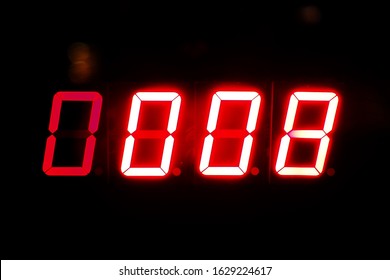 red light number zero zero zero eight.  No. 0008 on black background. Led digital light alarm clock. - Powered by Shutterstock