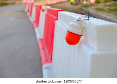 The Red Light On The Plastic Enclosure During The Repair Of The Bridge, Stretching Into The Distance Plastic Temporary Fence