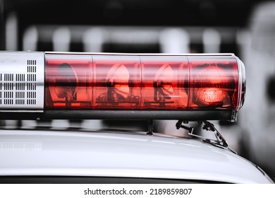 A Red Light On Top Of A Police Car