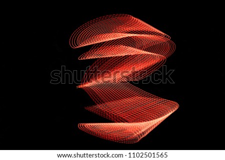 Red Light Painting, long exposure photography, loop and swirl against a black background