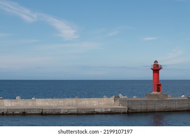 Red Lighthouse On A Harbour Wall