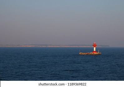 Red lighthouse in see