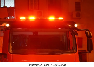 Red Lights Of A Fire Engine. Night Time. Fire Engine. Extinguishing The Fire. Closeup Of The Red Lights On Top Of A Fire Engine.