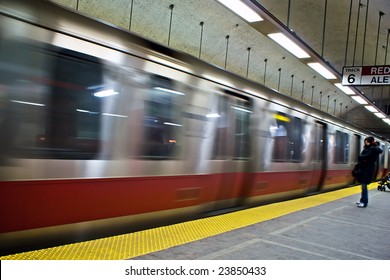 Red Line Train On The Boston Mbta In Motion Pulling Into The Subway Station Stop With Person Waiting