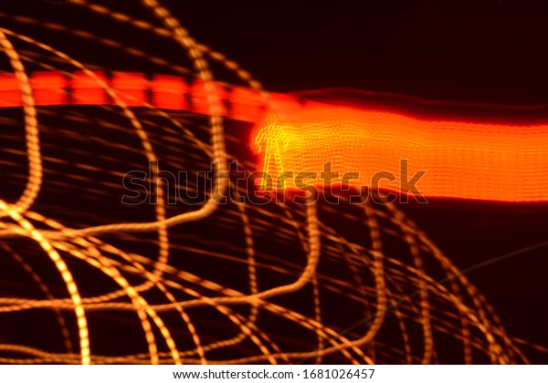 Red lines of light on a black background. \
Red\
traffic light. Traffic\
light