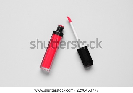 Red lipgloss on light background
