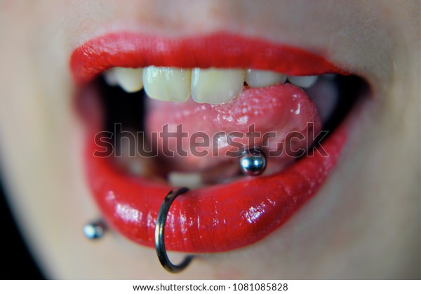 Red lips of a Woman with\
piercings