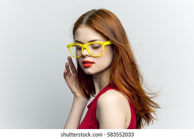Red lipstick and bright yellow sunglasses on women