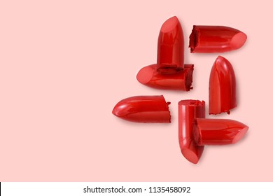 red lipstick bullet on pink pastel color background with copy space for promotion or advertising