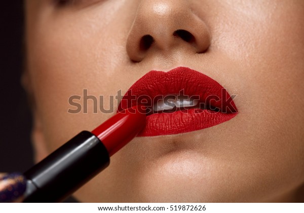 Red Lipstick. Closeup Of Woman Face With Bright Red\
Matte Lipstick On Full Lips. Beauty Cosmetics, Makeup Concept. High\
Resolution Image