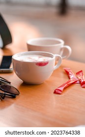 Red Lipstick Mark On A Coffee Cup On The Table In Cafe