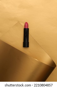 Red Lipstick Tube On A Luxurious Golden Background.