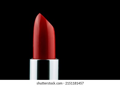 Red Lipstick Tube Upright Against A Black Background