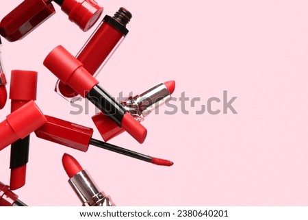 Red lipsticks flying on pink background