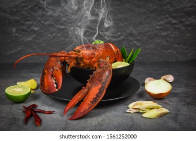 Red Lobster Spicy Soup Bowl / Cooked Seafood With Lobster Dinner Table And Spices Ingredients On Black Plate Thai Food