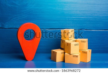 Red location pin pointer symbol and cardboard boxes. Improving the efficiency, speed and low cost of delivering goods to consumer. Business adaptation to quarantine measures, transition to online work