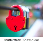 Red Lock in hart shape on rope bridge