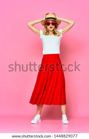 A red long skirt is a woman in the ducts and a matershinnaya with a head on a pink background                      