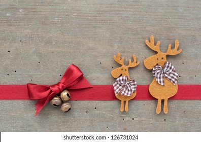 Red Loop, Reindeer And Bells On Wooden Ground