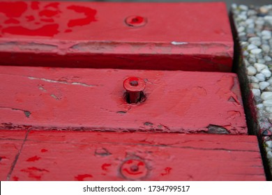 Red Loose Screw On A Bench