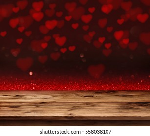 Red Love Heart In A Dark Background In Front Of A Empty Wooden Table For A Valentines Day Concept