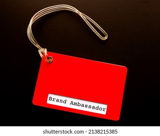 Red Luggage Tag With Text BRAND AMBASSADOR, Refer To Person Employed By Organization Or Business Owner To Represent Brand In Positive Image To Increase Brand Awareness