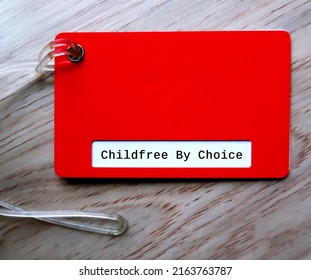 Red Luggage Tag With Text CHILDFREE BY CHOICE, Concept Of  Voluntary Choice Not To Have Children, Not Wanting Children And Having No Desire To Take On The Burden Of Parenthood