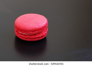 Red Macaron Cake On A Black Table