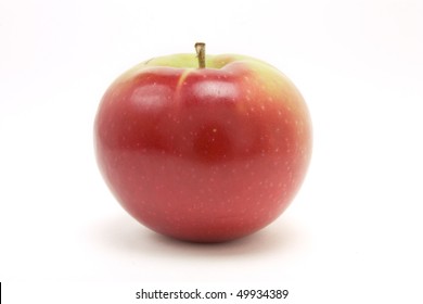 Red macintosh apple from low viewpoint isolated against white background.