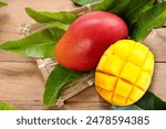 Red mango with mango cubes in Bamboo basket on wooden table background, Fresh Red Elegant mango fruits on wooden background.