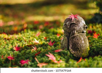 Red Maple leaf on head of Jizo  sculpture doll (little Japanese Buddhist monk doll rock) in Japanese Garden, Enkoji Temple, Kyoto, Japan. Autumn season japan - Powered by Shutterstock