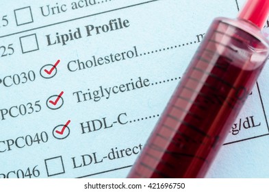 Red Mark Check On Cholesterol, Triglyceride And HDL-Con Request Form With Blood Sample In Blood Tube For Test.