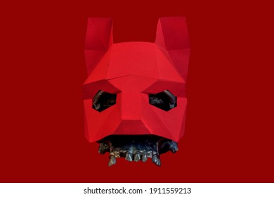 A Red Mask Is Worn On A Black Skull On A Red Background. Stylish And Beautiful Red Animal Mask With Ears On A Red Background. Mask Of A Wolf, Fox, Dog, Cat.