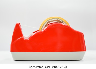 Red Masking Tape Cutter On Table On White Background.