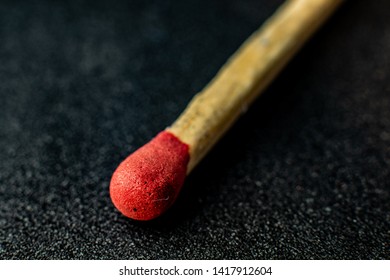 Red match head on dark, rough background. Macro photography.  - Shutterstock ID 1417912604