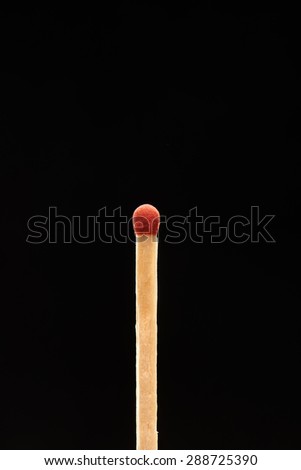 Red match isolated on black background