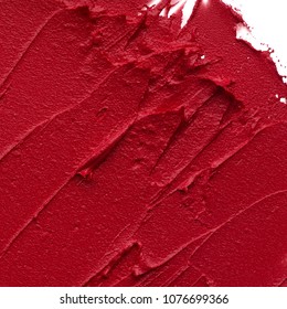 Red matte texture of lip gloss background. Red creamy lipstick texture background
