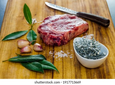 Red Meat With Bowl Of Iron Nails On Wooden Board 