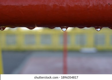 A Red Metal Bar Chained To Ice
