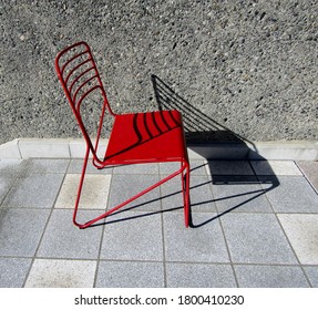 Red Metal Chair On Tile Floor