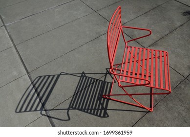 Red Metal Chair Shadow On Concrete